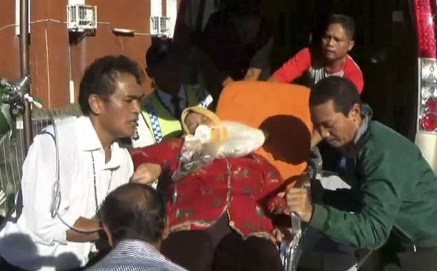 In this image made from video, an injured passenger of Etihad Flight EY474 receives medical treatment at the health facility at Soekarno-Hatta International Airport in Cengkareng, in the outskirts of Jakarta, Indonesia, Wednesday, May 4, 2016. Dozens of passengers and a crew member aboard the flight were injured Wednesday when their plane ran into sudden turbulence as it prepared to land in the Indonesian capital, Jakarta. (AP Photo/APTN)