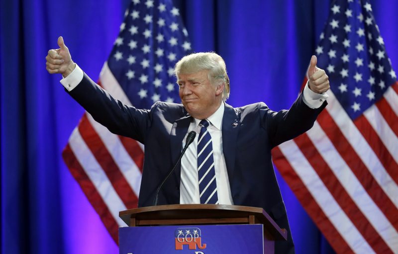 Republican presidential candidate Donald Trump acknowledges the crowd after addressing a GOP fundraising event, Tuesday, Aug 11, 2015, in Birch Run, Mich. Trump attended the Lincoln Day Dinner of the Genesee and Saginaw county Republican parties. (AP Photo/Carlos Osorio)